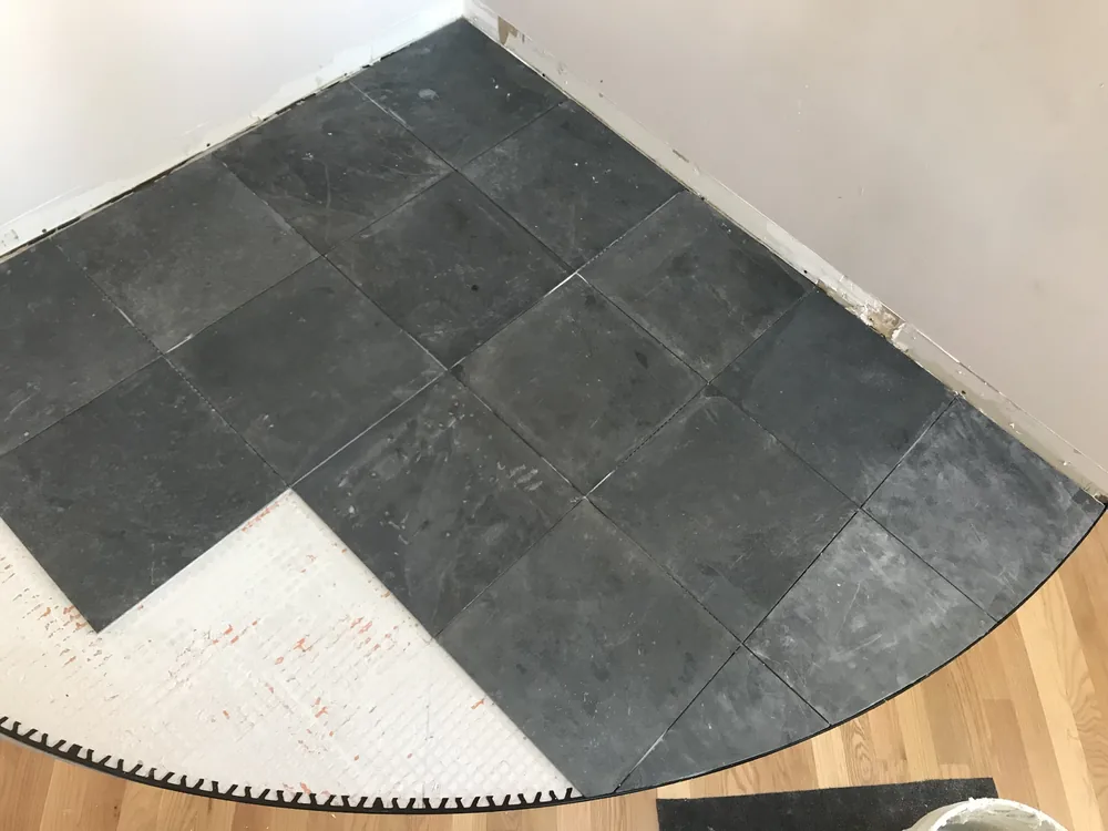 Curved slate hearth inlay, mid-install by Creative Construction Concepts