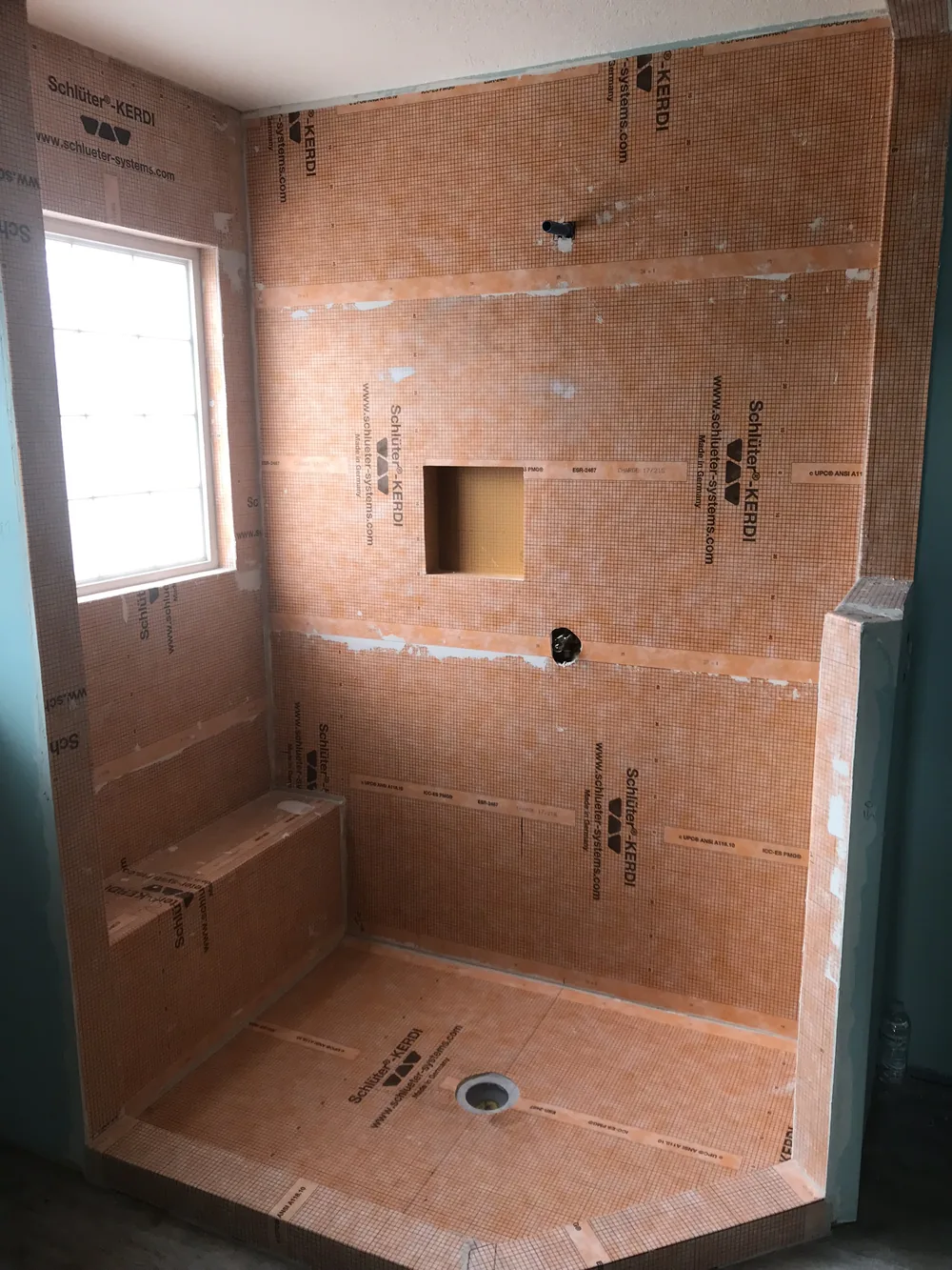 Full shower waterproofing before a single tile goes on by Creative Construction Concepts
