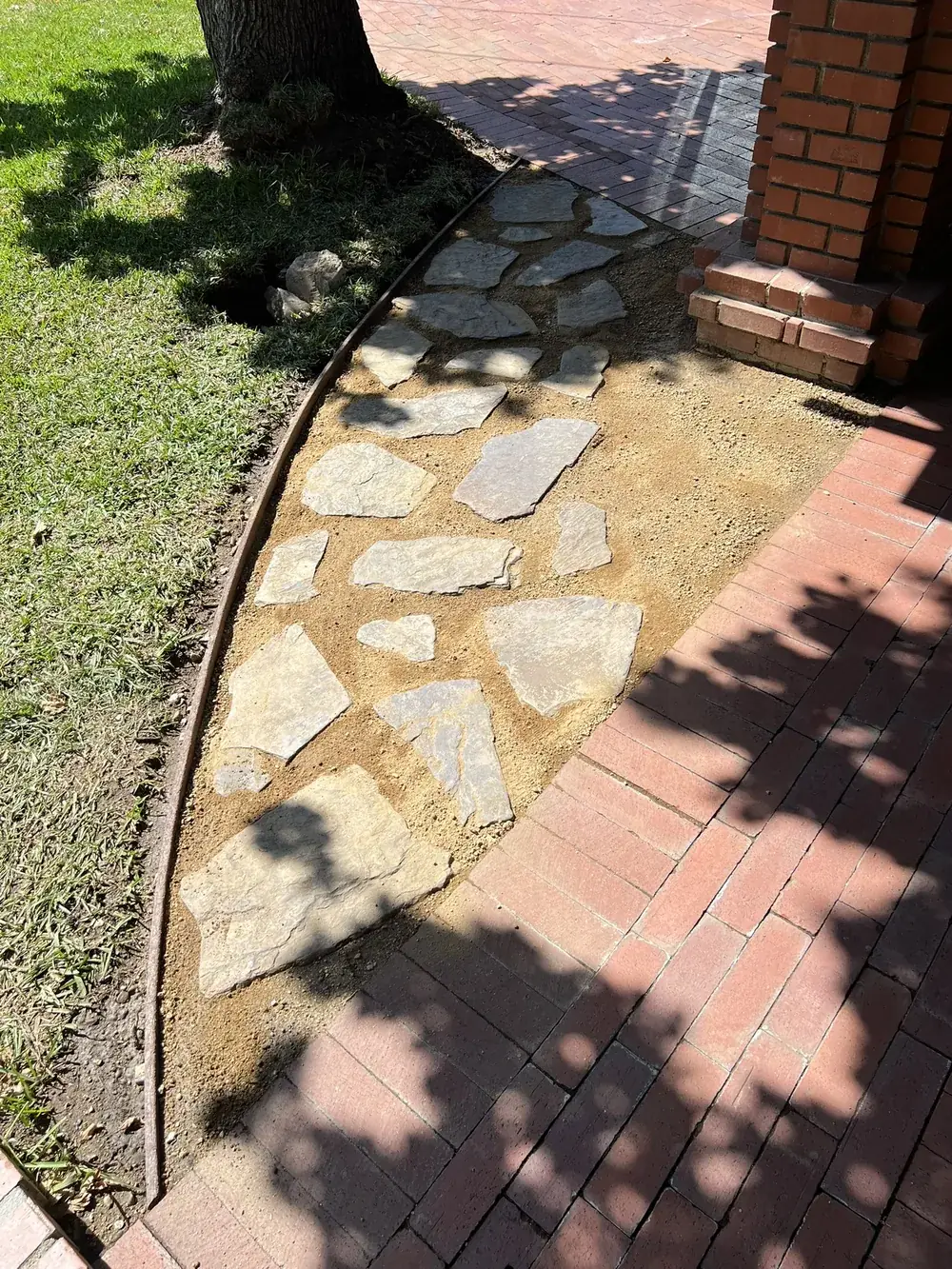 Flagstone path with brick border by Creative Construction Concepts