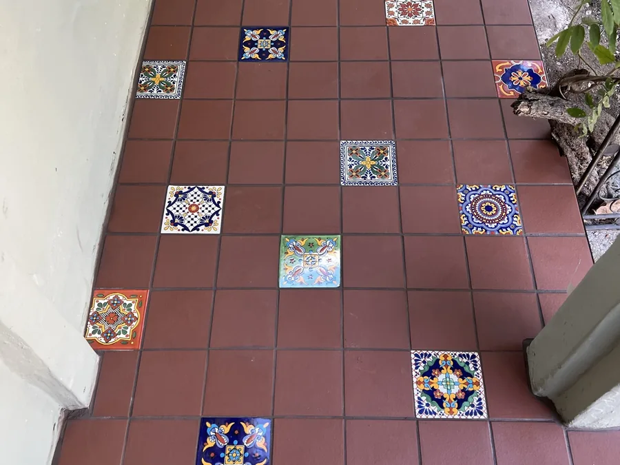 Terracotta patio with hand-painted Talavera accents by Creative Construction Concepts