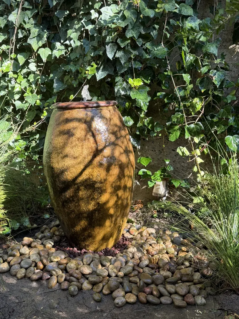 Ceramic urn fountain water feature by Creative Construction Concepts