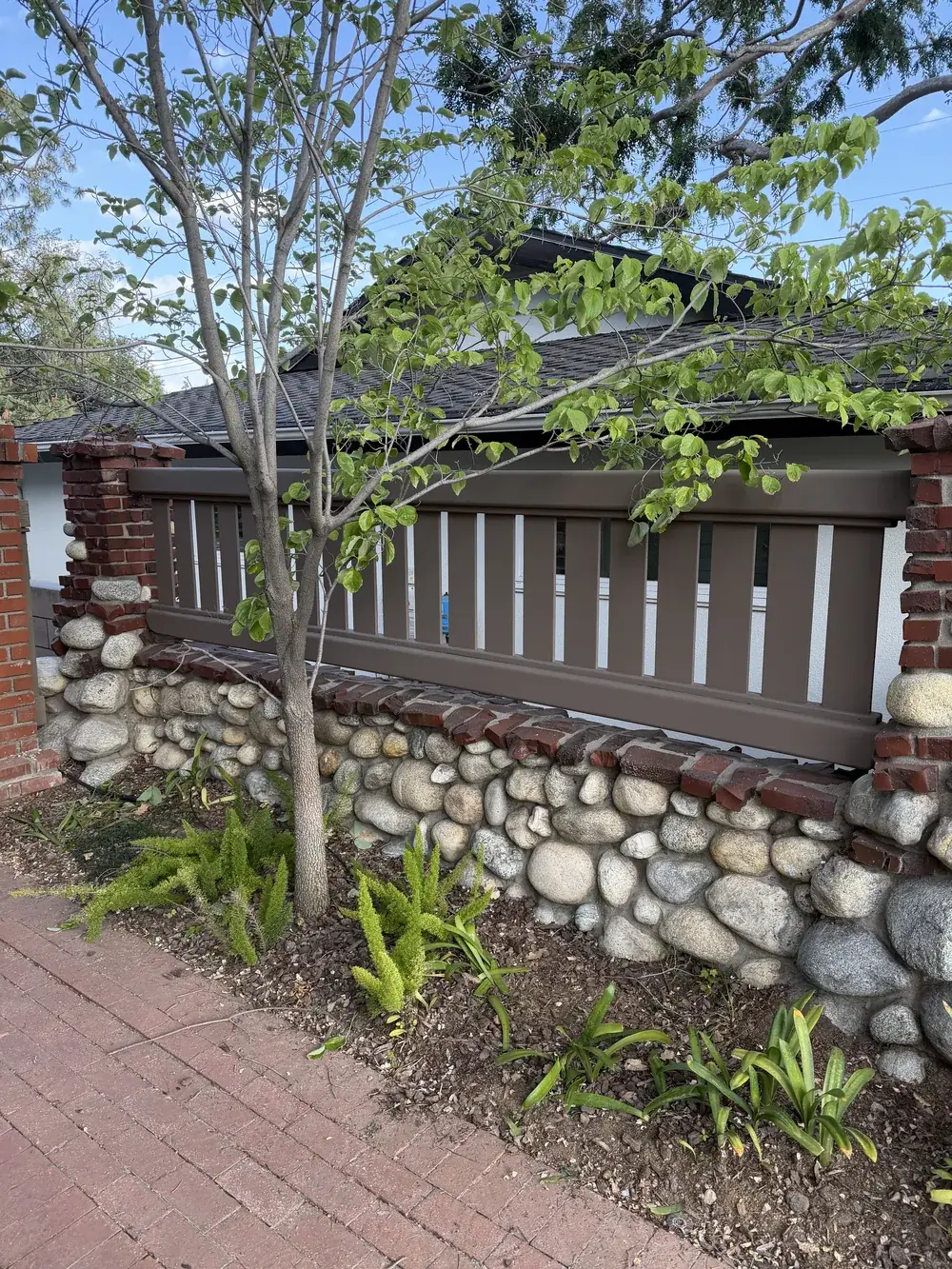 River-rock stone veneer wall by Creative Construction Concepts