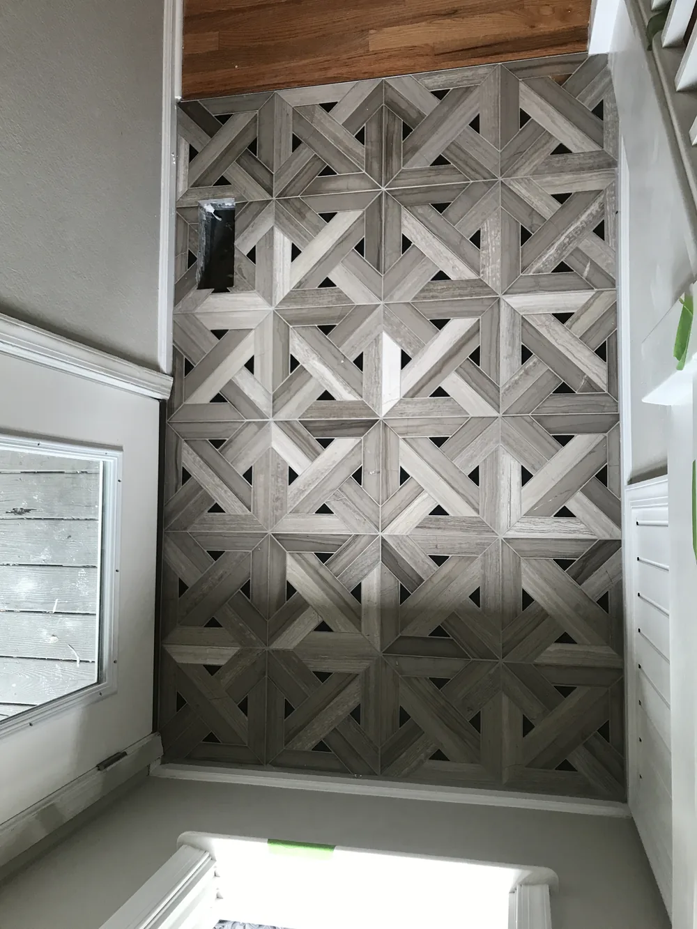 Parquet-pattern stone tile floor by Creative Construction Concepts