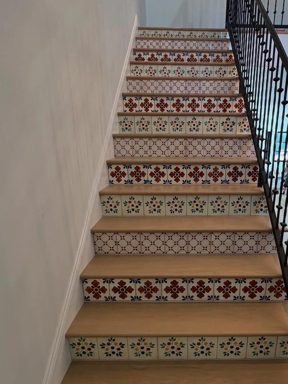 Hand-painted Spanish tile stair risers by Creative Construction Concepts