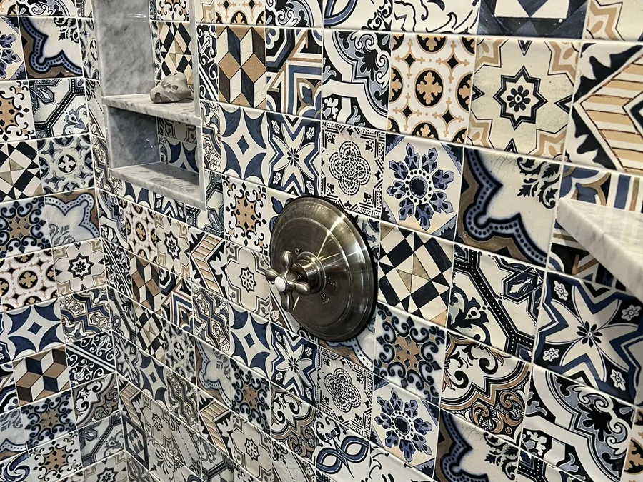 Patterned Talavera shower wall with a built-in niche by Creative Construction Concepts