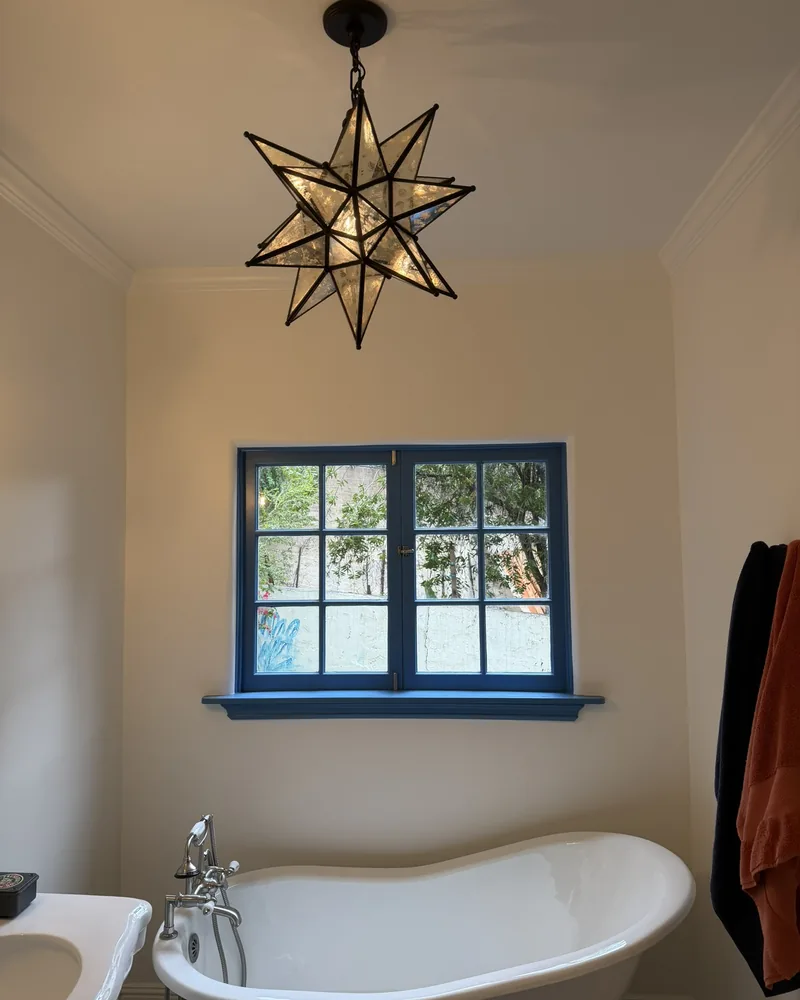 Clawfoot tub bath with a star pendant, by Creative Construction Concepts in Los Angeles
