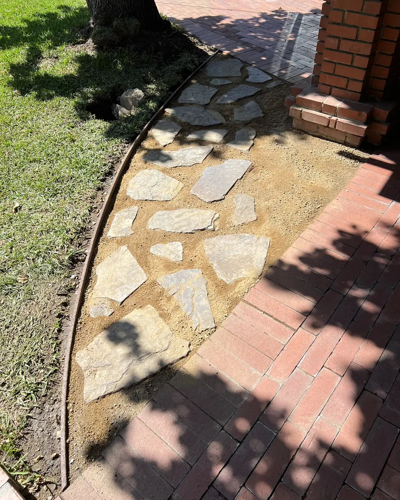 Flagstone path with a brick border, by Creative Construction Concepts in Los Angeles