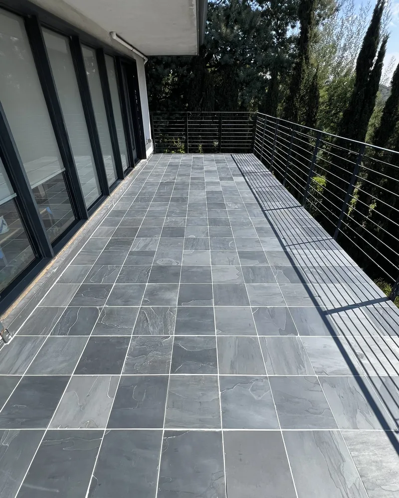 Slate tile deck with a cable rail, by Creative Construction Concepts in Los Angeles
