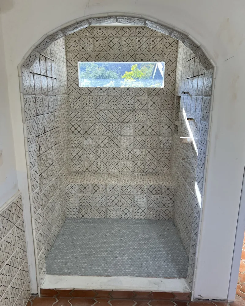 Arched walk-in shower in mosaic tile, by Creative Construction Concepts in Los Angeles