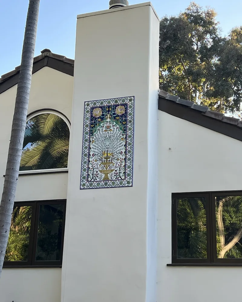 Exterior tile mural set into a Spanish stucco facade, by Creative Construction Concepts in Los Angeles