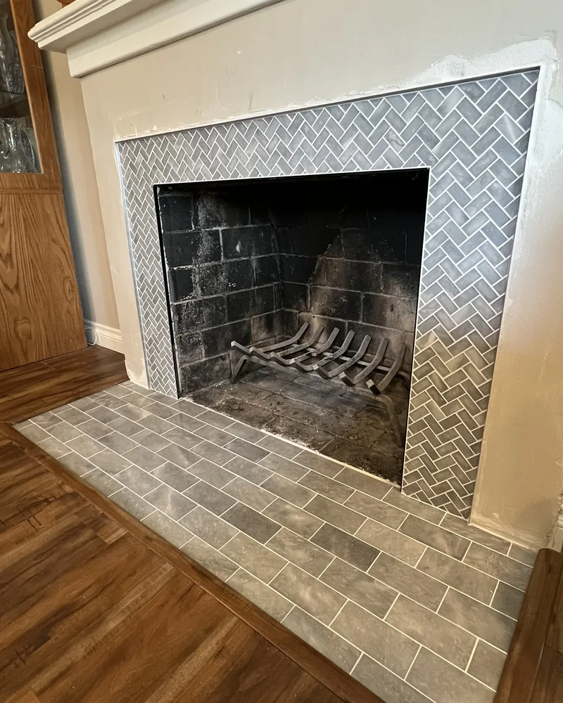 Herringbone tile fireplace surround and hearth, by Creative Construction Concepts in Los Angeles